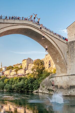 Man jumping from a very high ancient bridge in Mostar, Bosnia and Herzegovinaのeditorial素材