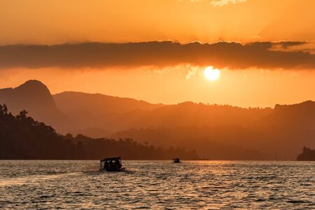 Beautiful landscape of Cheow Lan lake in Khao Sok National Park at sunsetの写真素材