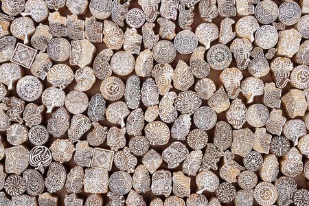 Wooden stamps printing blocks hand carved for sale on the street market in India.の写真素材