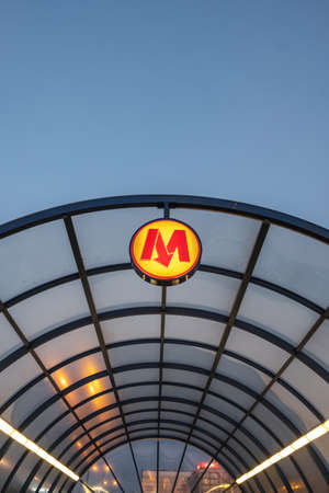 Warsaw metro sign at entrance to underground at night.のeditorial素材
