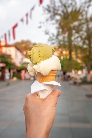 Turkish ice cream Dondurma in hand on the background of the Kas town in Turkeyの写真素材