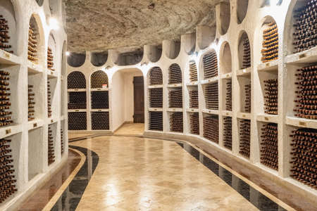 Wine bottles stacked up in old wine cellar close-upのeditorial素材