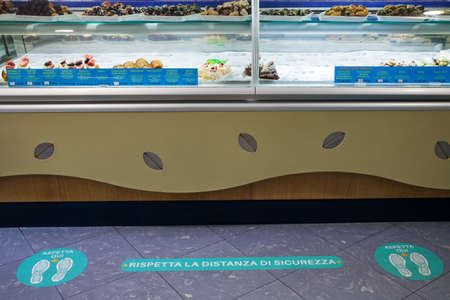 Footprint sign keep distance for stand in italian cafe bar. Coronavirus, Covid-19 virus crisis in Italy.のeditorial素材