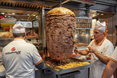 Chef cutting traditional Turkish food Doner Kebab in the restaurant in Istanbul, Turkey.のeditorial素材