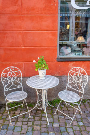Table and two chairs in street cafe in Porvoo, Finland.のeditorial素材