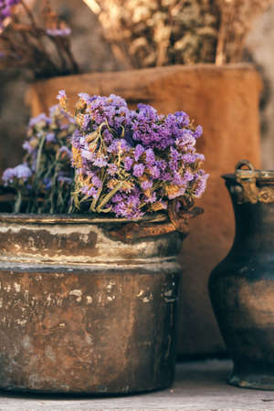 Closeup of a bouquet of dried flowers in vintage metal vaseの写真素材