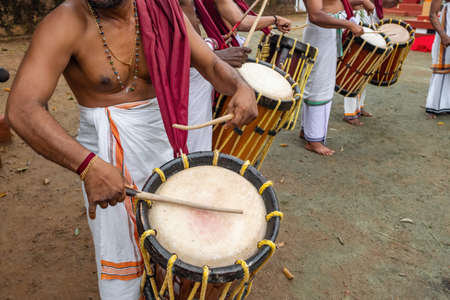 Indian men play traditional percussion drum Chenda in Kerala, Indiaの写真素材
