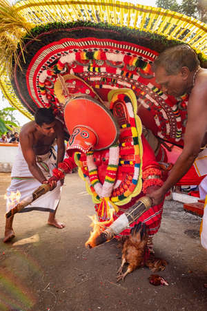 Theyyam artist perform during temple festival in Payyanur, Kerala, India.のeditorial素材