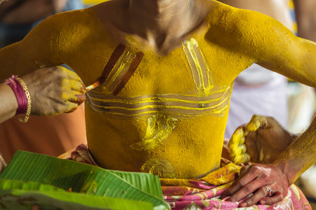 Theyyam artist preparing to perform during temple festival in Payyanur, Kerala, India.の写真素材