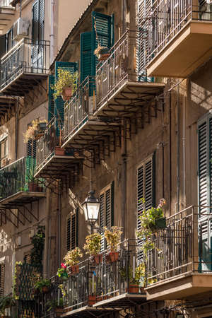 Building exterior with windows and balconies in Sicily, Italy.の写真素材