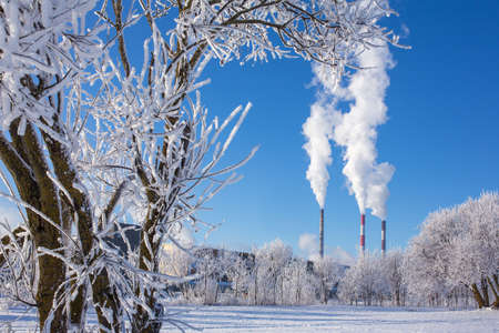 Thermal power station with smoking pipes in winterの写真素材