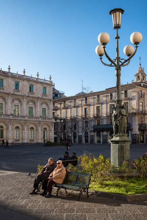 Unidentified senior men enjoying the sun at the Duomo square in Catania, Sicily, italyのeditorial素材