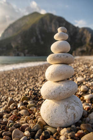 Balance stones on the beach at sunriseの写真素材