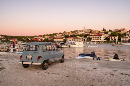 Vintage car parked in small harbour of the Mediterranean town Seget Donji near the Trogir town, Croatiaのeditorial素材