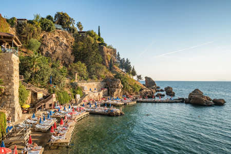 Unidentified people sunbathing on the small beach in Kaleici old town of Antalya.のeditorial素材