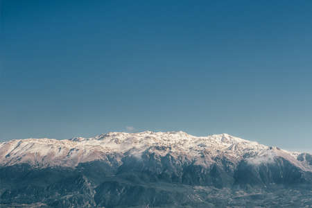 Snowy mountain range against the deep blue sky.の写真素材