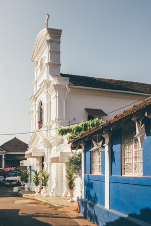 Old Portuguese christian church at picturesque street in Panjim, Old Goa, Indiaの写真素材