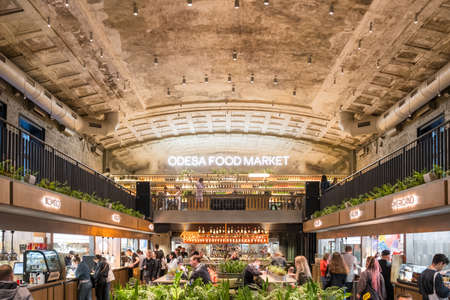 Interior of the Odessa Food Market modern urban cafe with different street food vendors in Odesa, Ukraineのeditorial素材
