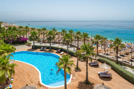 Luxury five star hotel with a swimming pool and white sand beach on Ionian sea coast in Albaniaのeditorial素材