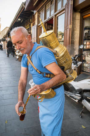 A street vendor pours a glass of traditional drink made with licorice root, Gaziantep, Turkeyのeditorial素材