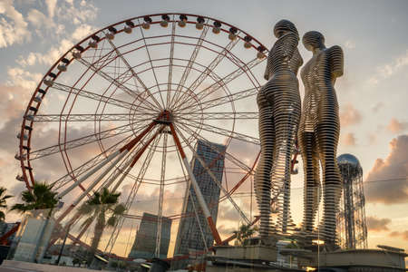 The Ferris wheel and the statue of Ali and Nino on the embankment of Batumi, Georgiaのeditorial素材