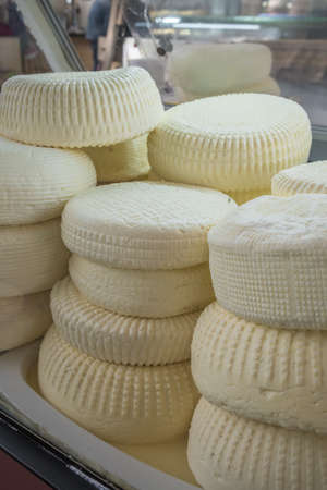 Closeup of piles of round homemade traditional soft cheese in the market in Georgia.の写真素材