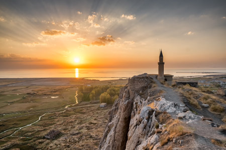 Sunset over the Van castle and Van lake with a minaret.の写真素材