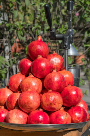 Pile of the fresh ripe pomegranates in small street food stallの写真素材