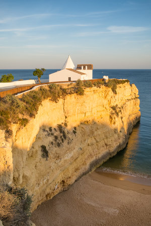 Sunset view of the church Senhora de Nossa, Algarve region, Portugalの写真素材