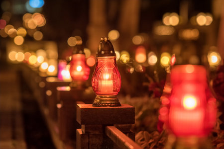 Candle lights at the cemetery at night in Poland during All Saints Dayの写真素材