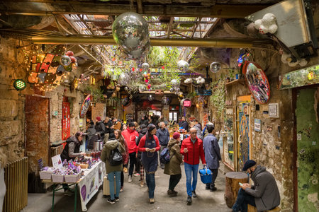 Unidentified people hang out at the entrance to Szimpla Garden ruin club in Budapestのeditorial素材