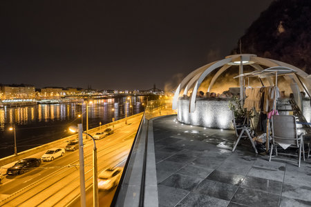 Unidentified people enjoying rooftop thermal pool at night in Budapest.のeditorial素材