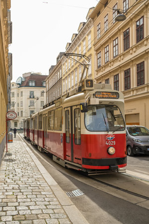 Traditional red electric tram riding in Vienna, Austriaのeditorial素材