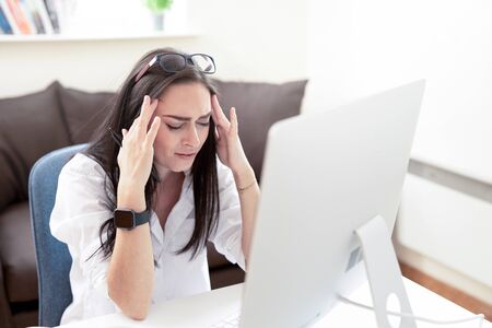 Attractive Business Woman Having Headache While Working on Home Desktop. Stressed And Depressed...