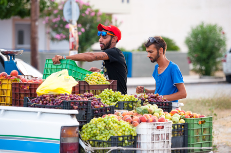 NEOI POROI, GREECE - AUGUST 03 2015: Beach Fruit Sellersのeditorial素材