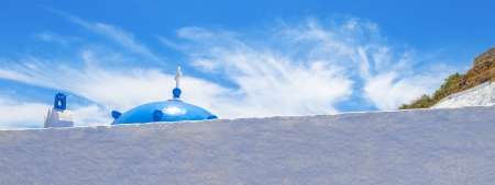 Greece Santorini island wide angle view of colorful church with wooden blue  windows with whitewased walls in oia  at summer during daylightの写真素材