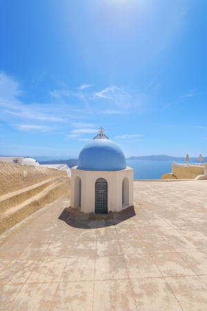 Greece Santorini island wide angle view of colorful church with wooden blue  windows with whitewased walls in oia  at summer during daylightの写真素材