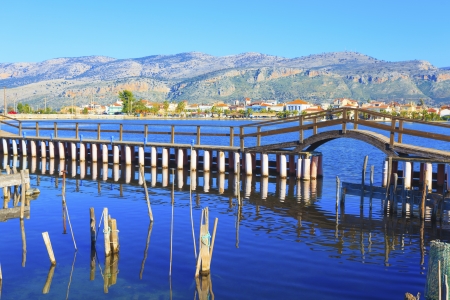 Greece, Beautifull reflections of wooden fplatform bridge on water  in Aitoliko in Central Greeceの写真素材