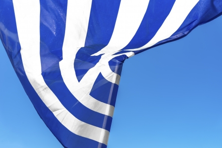 Greece, greek flag waving with blue sky backgroundの写真素材