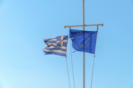 Greek flag waving with europes union flag with blue skyの写真素材