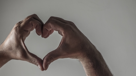 Mans hands forming a heartの写真素材