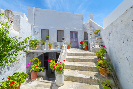Greece Santorini island in cyclades colorful view of whitewashed houses among small walk paths that cross the island with wooden door frames and flower potsのeditorial素材