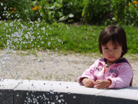 A child is looking at a fountain