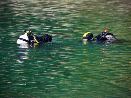 Two divers above water at a lakeの写真素材