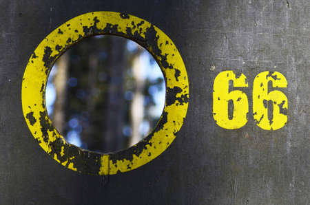 Board with a yellow circle and the number 66の写真素材
