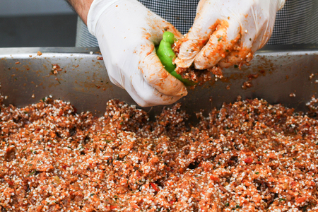 bell peppers being stuffed with a fillingの写真素材