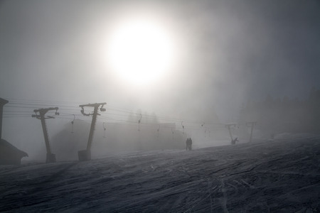 Skiers and snowboarders on a ski liftの写真素材
