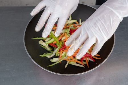 Chef in hotel or restaurant kitchen cooking only handsの写真素材