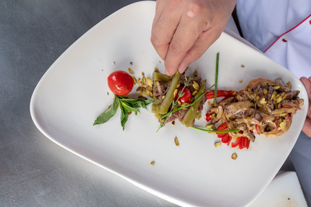 Chef in hotel or restaurant kitchen cooking only handsの写真素材