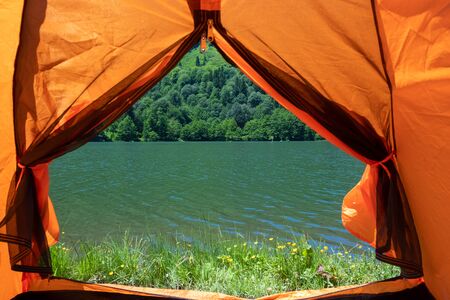 Camping tent at scenic campsite on a lakeの写真素材